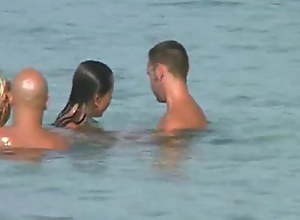 two swingers couples on the shore