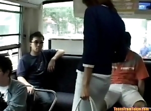 A young Asian girl enters a public bus and sits bristles http://alljapanese.net